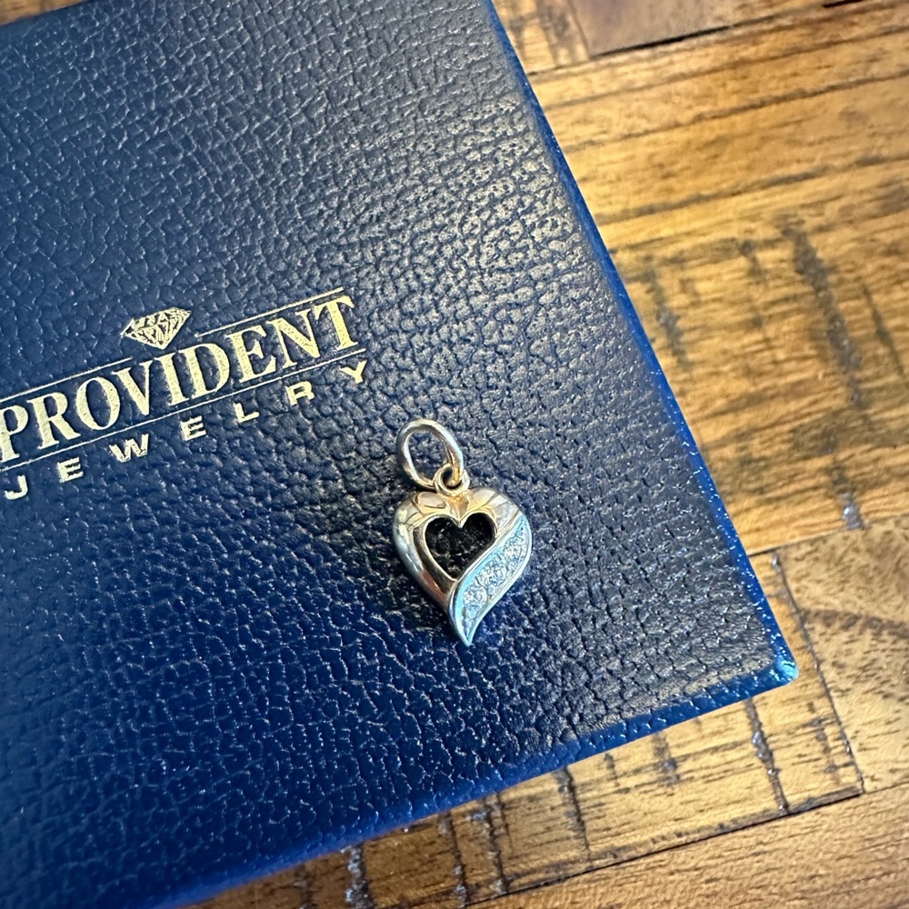 Heart shaped 14k gold pendant with three stones. Brand new.